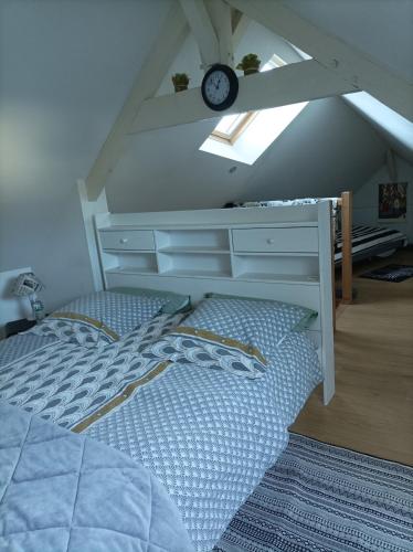 a bedroom with a bed with a desk and a clock at Bord Charente face Pôle Magelis - T2b Triplex in Angoulême