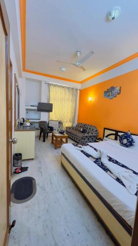 a bedroom with a bed and a living room at KDM Hotel Sai Geeta Shirdi a walk away from Saibaba Temple in Shirdi