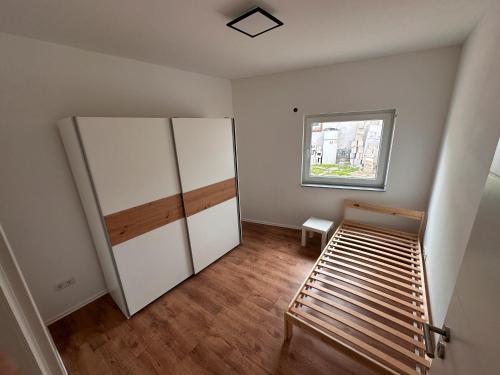 a room with a white cabinet and a window at Cozy Ground Floor Apartment in Lüssum