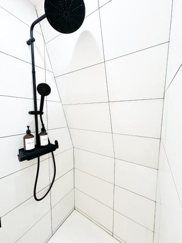 a bathroom with a shower with white tiles at Le Zen Kyoto in Lambersart