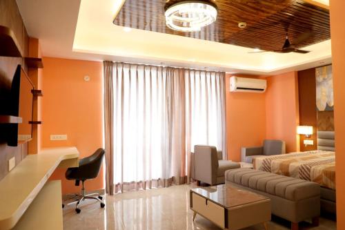 a hotel room with a bed and a couch at Aryan Home Stay Lucknow in Lucknow