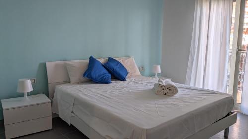 a bedroom with a bed with two clocks on it at Vulcano Etna Mare in Giardini Naxos