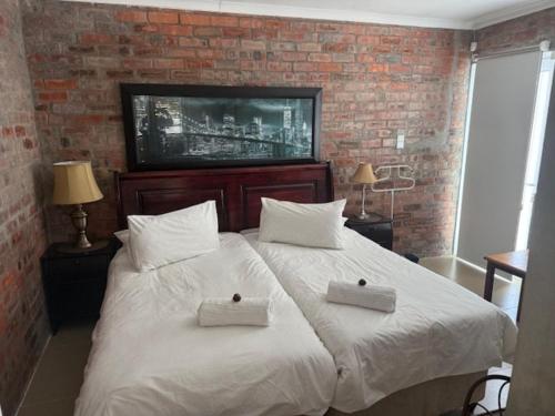 a bedroom with a large bed with two white pillows at Classic Air B&B in Pearly Beach