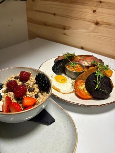 a plate of breakfast food with eggs and fruit on a table at The Old Mill Hotel in Salisbury