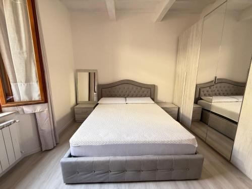 a small bedroom with two beds in it at Duomo Appartamento in Massa Marittima