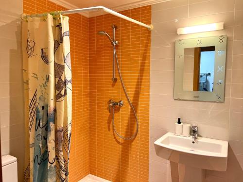 a bathroom with a shower and a sink at Sea View 2-bedrooms Apartment in La Tejita