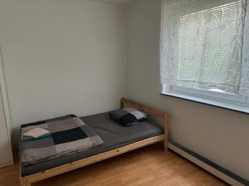 a small bed in a room with a window at WG Riedau in Riedau