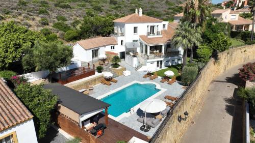 an aerial view of a house with a swimming pool at Home4u Mediterranean Sea Views Villa Alkaff in Manilva