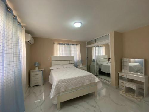 ein Schlafzimmer mit einem Bett und einem Fernseher darin in der Unterkunft apartamento moderno lo mejor de Santiago in Santiago de los Caballeros