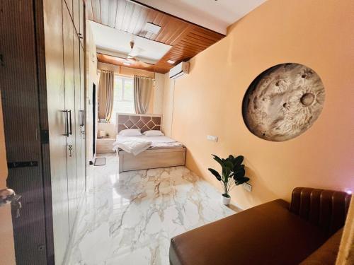 a small room with a bed and a bathroom at Row House Near US Consulate BKC & NMCC in Mumbai