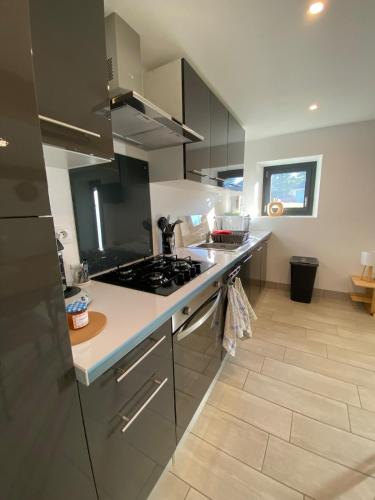 a kitchen with a stove and a counter top at Maison Gîtes de l'étang caché in Chamboulive