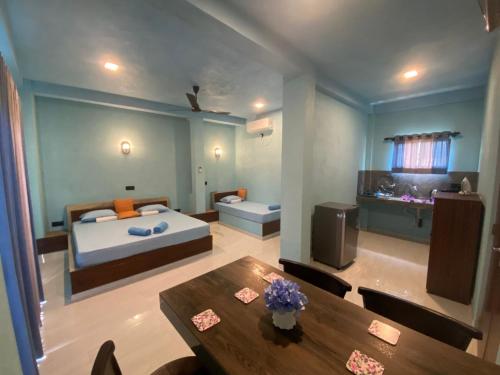 a bedroom with a bed and a table in a room at The Shore Residence in Hikkaduwa