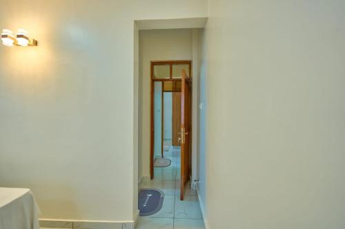 a hallway with a door leading into a room at Royal Suites in Mombasa