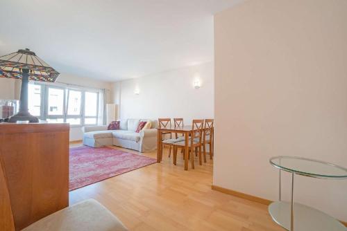 a living room with a couch and a table at 1 Minute to the Metro and 2 to the Supermarket in Lisbon