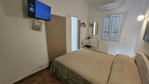 a hospital room with a bed and a flat screen tv at Stella Marina Apartment in Fregene