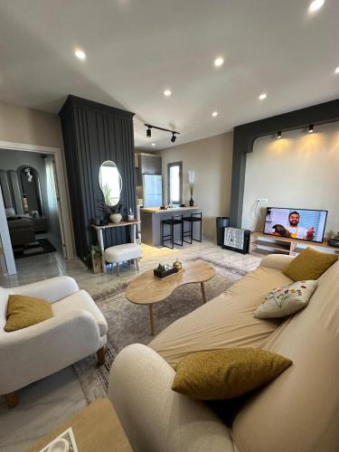a living room with two couches and a flat screen tv at Stylish Loft Apartment with Private Terrace in Erdemli
