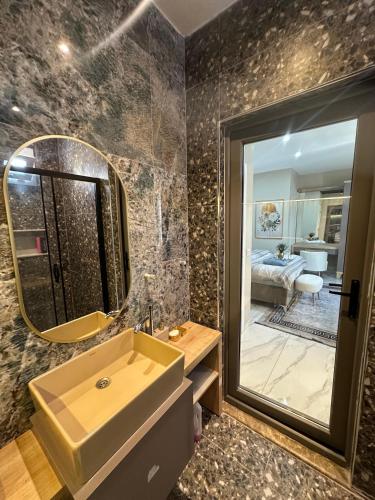 a bathroom with a sink and a mirror at Stylish Loft Apartment with Private Terrace in Erdemli