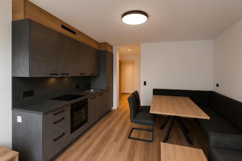 a kitchen with a wooden table and a dining room at Appartment Krimmler Bergtraum in Krimml