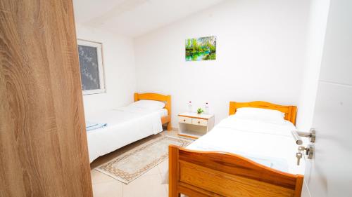 a bedroom with two beds and a door open at Skyline Suites Belgrade in Ledine