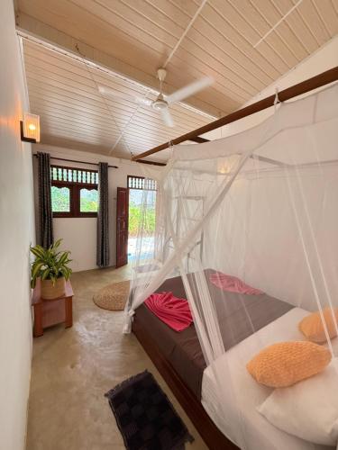 une chambre avec un lit superposé dans une pièce dans l'établissement Shoreline House Hiriketiya, à Nilwella