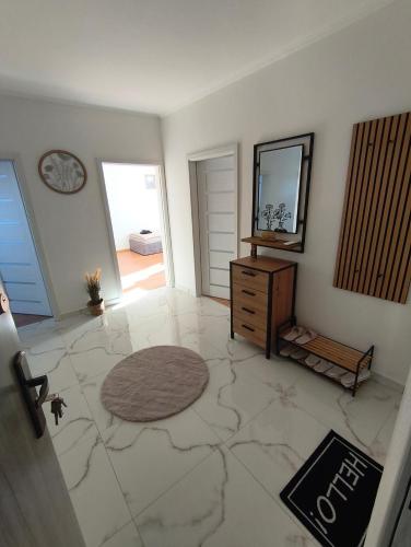 a living room with a dresser and a mirror at APARTMÁN - 3 izbový byt in Veľký Krtíš
