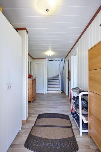 a hallway of a house with a stairway with a rug at Fjord House in Fornes