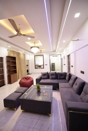 a living room with a couch and a coffee table at The Laxmi Royale Villa in Jaipur