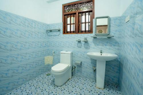 希克杜沃The Quiet House - Hikkaduwa的蓝色的浴室设有卫生间和水槽