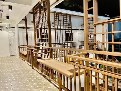 a library with wooden benches in a room at Secret Corner Boutique Hostel in Chiang Rai