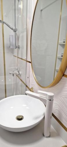 a bathroom with a white sink and a mirror at JULIANNA APARTMAN Budapest FREE PARKING in Budapest