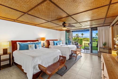 a bedroom with two beds and a view of the ocean at Maui Eldorado Condo A104 in Kaanapali
