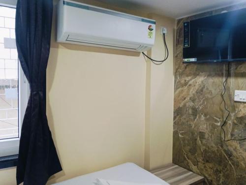 a room with a air conditioner on the wall at Marquis Luxe Guest House in Kolkata