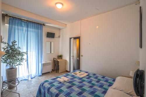 a bedroom with a bed and a large window at Hotel Continental in Pesaro