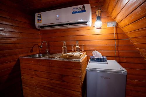 a kitchen with a sink and a washing machine at Marbella bungalows desert private camp in Bidiyah