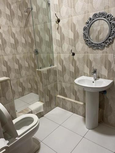 a bathroom with a toilet and a sink at AK Guesthouse in Maputo