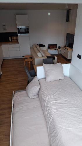 a large room with two beds and a room with other beds at Studio Meulebeke Centre in Tielt