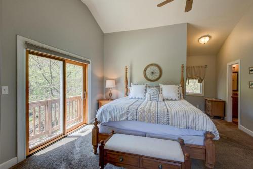 a bedroom with a bed and a large window at Sugar Rush in Sugar Mountain