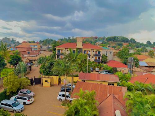 a town with cars parked in a parking lot at Palm Gardens Guesthouse in Kampala