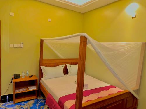 Ένα ή περισσότερα κρεβάτια σε δωμάτιο στο Palm Gardens Guesthouse