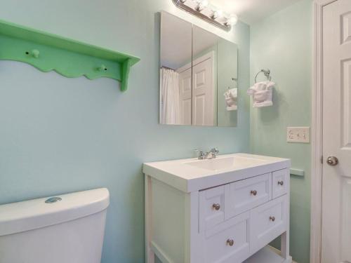a bathroom with a white sink and a mirror at Tybee Tyme Lower in Tybee Island