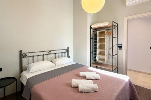 a bedroom with a bed with two towels on it at Mandarini Luxury Villa Pefkochori 5 bedrooms 12 guests in Pefkohori