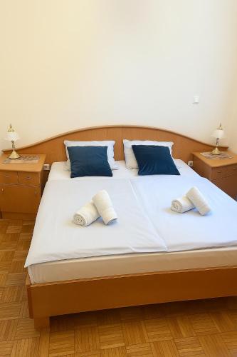 a bedroom with a large bed with two pillows at Ana Marija Apartment - Vila Golf in Rogaška Slatina