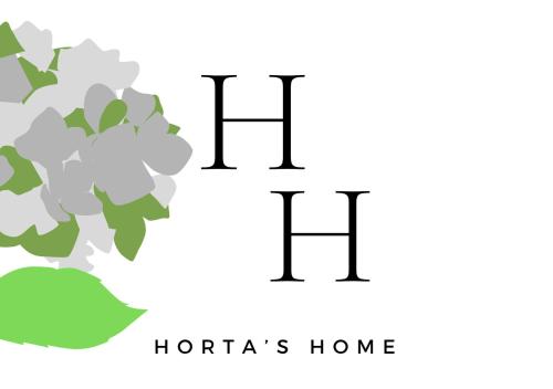 a logo for a hotel or home with flowers at Horta's home in Tirana