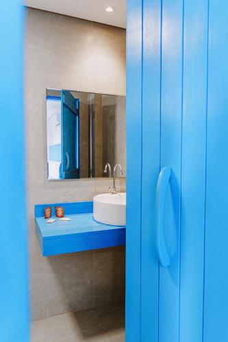 a bathroom with a sink and a mirror at KEFI POUSADA in Maragogi