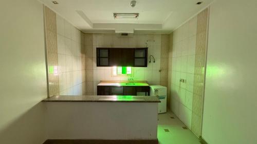 a kitchen with a stove and a green light at Smart Entry Room Grnada in Riyadh