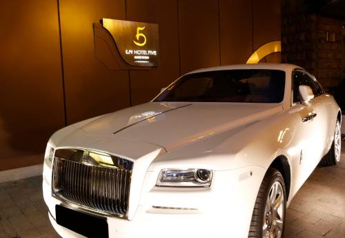 a white luxury car parked in a garage at LN Hotel Five in Guangzhou