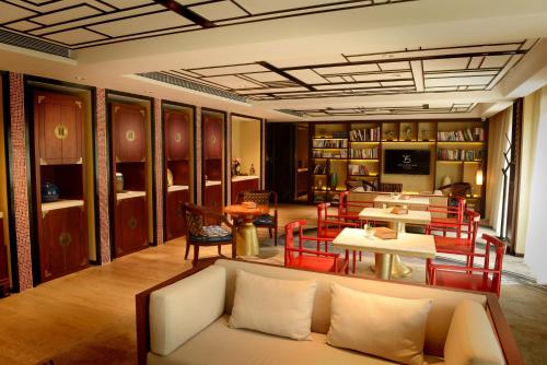 a living room with a couch and tables and chairs at LN Hotel Five in Guangzhou