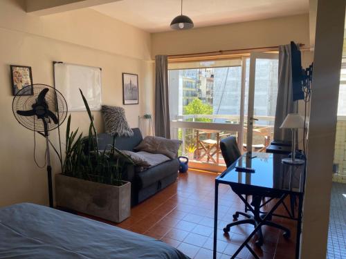 ein Wohnzimmer mit Sofa und Tisch in der Unterkunft Monoambiente Zona Güemes in Mar del Plata