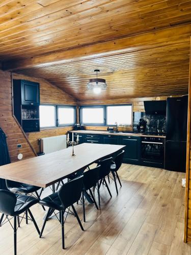a kitchen with a large wooden table and chairs at A-Frame Retreat Vulcan in Vulcan
