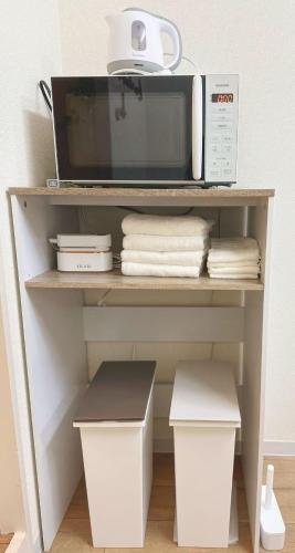 a microwave oven sitting on top of a shelf at Shinjuku Downtown新宿 in Tokyo